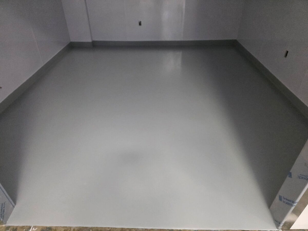 Storage room floor coated in gray epoxy