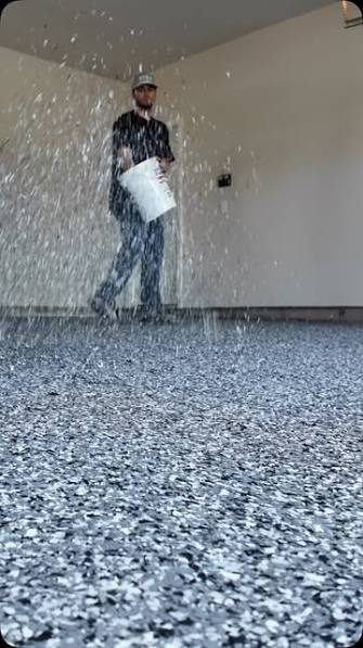 Installer broadcasting flake onto a fresh garage floor